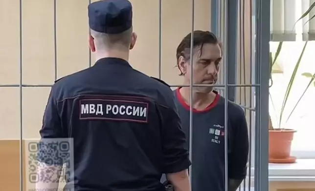 FILE - In this photo taken from video released by Khamovnichesky District Court press service on July 18, 2024, U.S. citizen Michael Travis Leake stands in a cage in a courtroom in the Khamovnichesky District Court, in Moscow, before being convicted of drug trafficking charges and sentenced to 13 years in prison. (Khamovnichesky District Court via AP, File)
