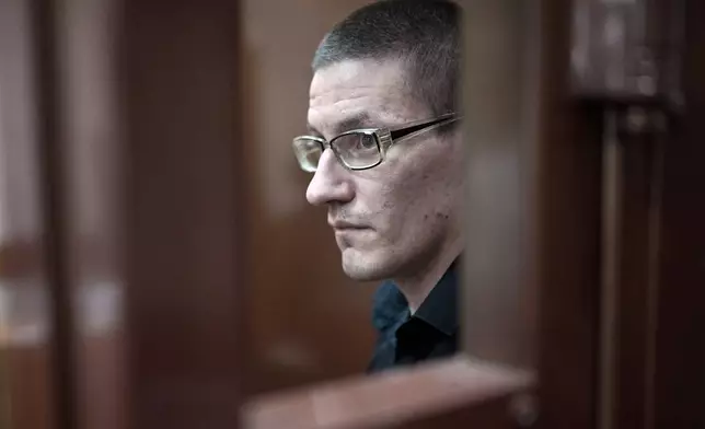 FILE - Robert Woodland, a Russia-born U.S. citizen, stands in a glass cage during a court hearing, July 4, 2024, in Moscow, Russia. (AP Photo/Alexander Zemlianichenko, File)