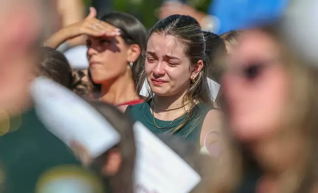 A student mourns during a vigil on the Florida State campus at Langford Green, Tallahassee, Fla., Friday, April 18, 2025, after a school shooting the day before. (AP Photo/Gary McCullough)