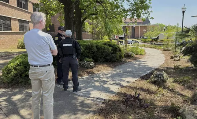 Dozens of patrol vehicles, including a forensics van, are stationed outside of Florida State University’s student union building, the scene of a shooting, Thursday, April 17, 2025, in Tallahassee, Fla. (AP Photo/Kate Payne)