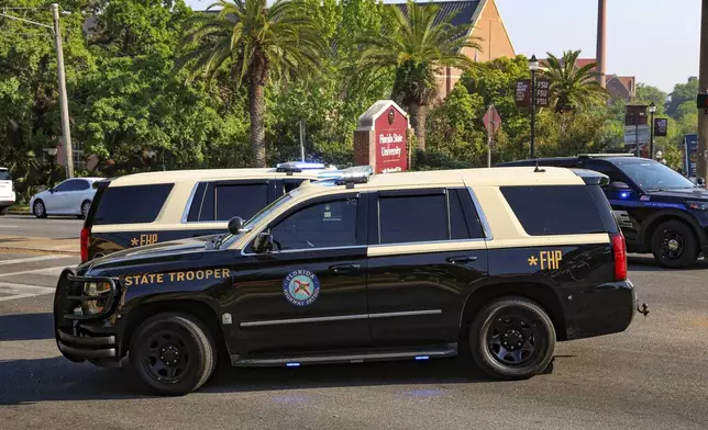 The Florida State Student Union building is seen behind law enforcement vehicles in Tallahassee, Fla., Thursday, April 17, 2025. (AP Photo/Gary McCullough)
