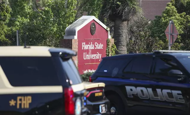 The Florida State Student Union building is seen behind law enforcement vehicles in Tallahassee, Fla., Thursday, April 17, 2025. (AP Photo/Gary McCullough)