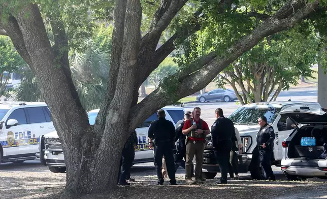 Law enforcement officers gather after a shooting at Florida State University in Tallahassee, Fla., Thursday, April 17, 2025. (AP Photo/Gary McCullough)
