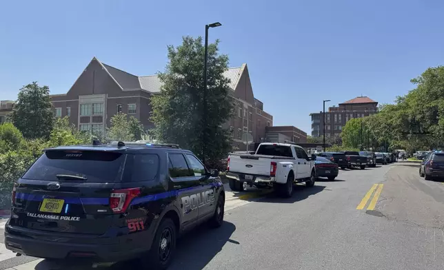 Dozens of patrol vehicles, including a forensics van, are stationed outside of Florida State University’s student union building, the scene of a shooting, Thursday, April 17, 2025, in Tallahassee, Fla. (AP Photo/Kate Payne)