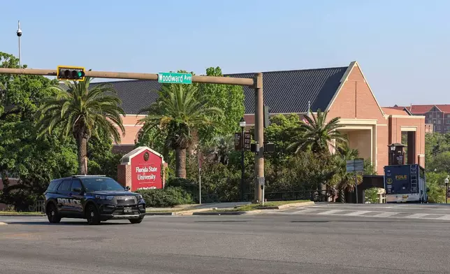 The Florida State Student Union building is seen behind law enforcement vehicles in Tallahassee, Fla., Thursday, April 17, 2025. (AP Photo/Gary McCullough)