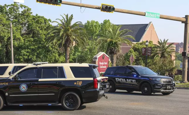 The Florida State Student Union building is seen behind law enforcement vehicles in Tallahassee, Fla., Thursday, April 17, 2025. (AP Photo/Gary McCullough)