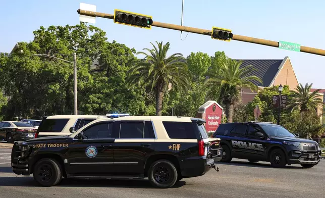 The Florida State Student Union building is seen behind law enforcement vehicles in Tallahassee, Fla., Thursday, April 17, 2025. (AP Photo/Gary McCullough)