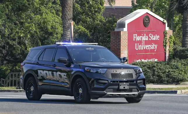 The Florida State Student Union building is seen behind law enforcement vehicles in Tallahassee, Fla., Thursday, April 17, 2025. (AP Photo/Gary McCullough)