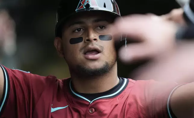 Arizona Diamondbacks' Gabriel Moreno (14) celebrates after scoring on a single from Corbin Carroll during the fifth inning of a baseball game against the Chicago Cubs, Friday, April 18, 2025, in Chicago. (AP Photo/Erin Hooley)