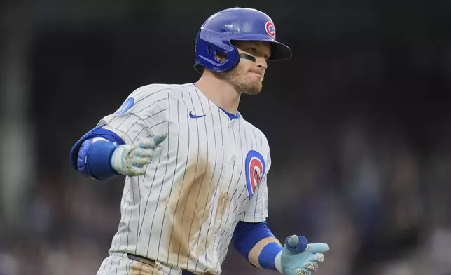 Chicago Cubs' Ian Happ runs the bases after hitting a grand slam during the seventh inning of a baseball game against the Arizona Diamondbacks, Friday, April 18, 2025, in Chicago. (AP Photo/Erin Hooley)