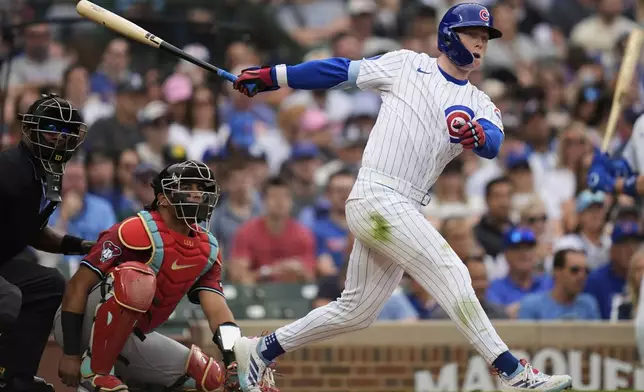 Chicago Cubs' Pete Crow-Armstrong (4) hits a double during the second inning of a baseball game against the Arizona Diamondbacks, Friday, April 18, 2025, in Chicago. (AP Photo/Erin Hooley)