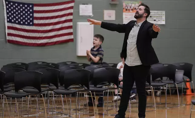 River Church Cincinnati pastor Cory Bowman, who is Vice President JD Vance's half brother and Cincinnati mayoral candidate, and RJ Symes, left, pray during Easter morning service in the Hays Porter Elementary School gym Sunday, April 20, 2025, in Cincinnati. (AP Photo/Carolyn Kaster)