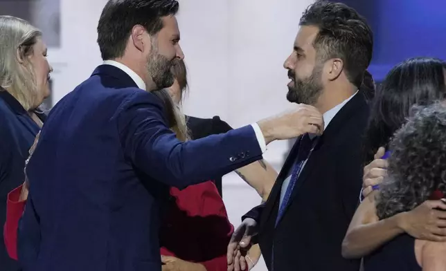Cory Bowman, half-brother of Republican vice presidential candidate Sen. JD Vance, R-Ohio, right, hugs Vance during the Republican National Convention, Wednesday, July 17, 2024, in Milwaukee. (AP Photo/J. Scott Applewhite)
