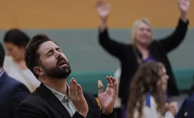 River Church Cincinnati pastor Cory Bowman, who is Vice President JD Vance's half brother and Cincinnati mayoral candidate, prays during Easter worship service in the Hays Porter Elementary School gym Sunday, April 20, 2025, in Cincinnati. (AP Photo/Carolyn Kaster)