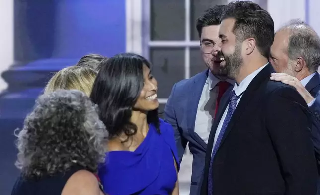 Cory Bowman, Vice President JD Vance's half-brother, from right, speaks with Usha Vance and others on stage during the Republican National Convention, Wednesday, July 17, 2024, in Milwaukee. (AP Photo/J. Scott Applewhite)