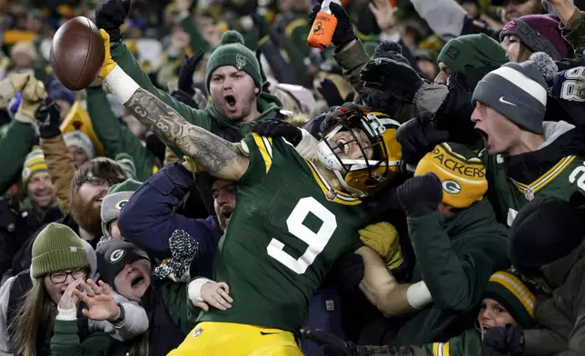 FILE - Green Bay Packers wide receiver Christian Watson (9) celebrates with fans after scoring a touchdown during the second half of an NFL football game against the Dallas Cowboys, Sunday, Nov. 13, 2022, in Green Bay, Wis. AP Photo/Matt Ludtke, File)