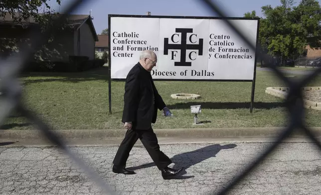 FILE - Catholic Bishop Kevin Farrell walks to speak to media outside the the Diocese of Dallas Catholic Conference and Formation Center on Oct. 20, 2014. (AP Photo/LM Otero, File)