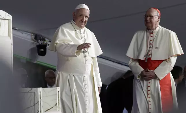 FILE - Pope Francis, left, is flanked by Cardinal Kevin Farrell during a vigil at Campo San Juan Pablo II in Panama City, Jan. 26, 2019. (AP Photo/Alessandra Tarantino, File )