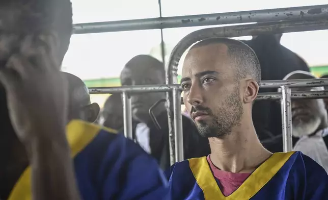 FILE - Benjamin Reuben Zalman-Polun sits in court in Kinshasa with 52 other defendants Friday June 7, 2024, accused of a role in last month's attempted coup in Congo led by little-known opposition figure Christian Malanga in which six people were killed. (AP Photo/Samy Ntumba Shambuyi, File)