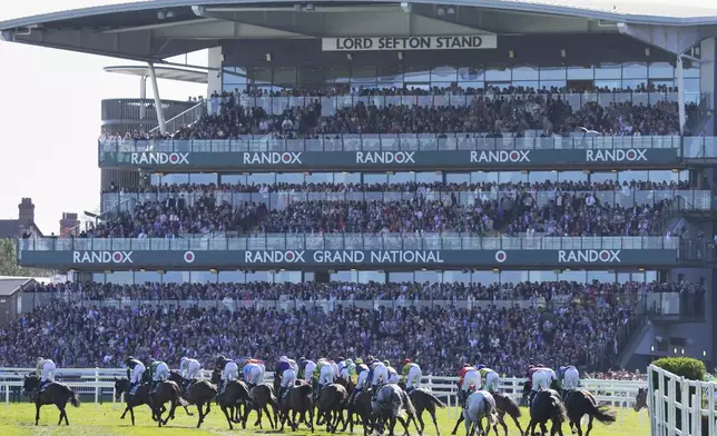 Horses compete in the Randox Grand National Handicap Steeple Chase race on the third day of the Grand National Horse Racing meeting at Aintree racecourse, near Liverpool, England, Saturday, April 5, 2025. (AP Photo/Ian Hodgson)