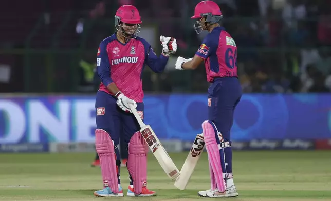 Rajasthan Royals' Vaibhav Suryavanshi, left, celebrates scoring runs with batting partner Yashasvi Jaiswal during the Indian Premier League cricket match between Rajasthan Royals and Gujarat Titans at Sawai Mansingh Stadium in Jaipur, India, Monday, April 28, 2025. (AP Photo/Surjeet Yadav)
