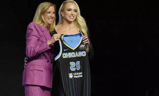 TCU's Hailey Van Lith, right, poses for a photo with WNBA commissioner Cathy Engelbert after being selected 11th overall by the Chicago Sky during the first round of the WNBA basketball draft, Monday, April 14, 2025, in New York. (AP Photo/Pamela Smith)