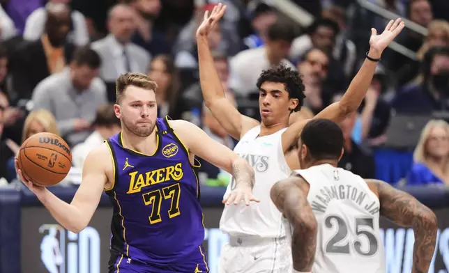 Los Angeles Lakers' Luka Doncic (77) makes a pass as Dallas Mavericks' P.J. Washington (25) and Max Christie, right rear, defend in the second half of an NBA basketball game in Dallas, Wednesday, April 9, 2025. (AP Photo/LM Otero)