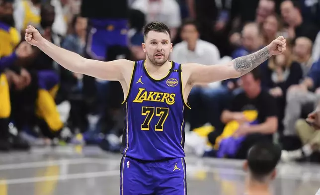 Los Angeles Lakers' Luka Doncic gestures to an official in the second half of an NBA basketball game against the Dallas Mavericks in Dallas, Wednesday, April 9, 2025. (AP Photo/LM Otero)