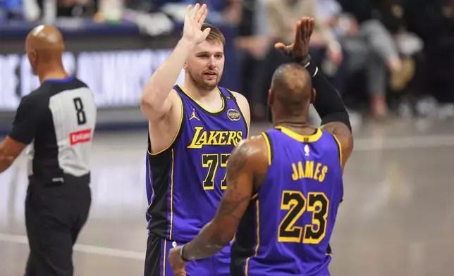 Los Angeles Lakers' Luka Doncic (77) and LeBron James (23) celebrate in the second half of an NBA basketball game against the Dallas Mavericks in Dallas, Wednesday, April 9, 2025. (AP Photo/LM Otero)