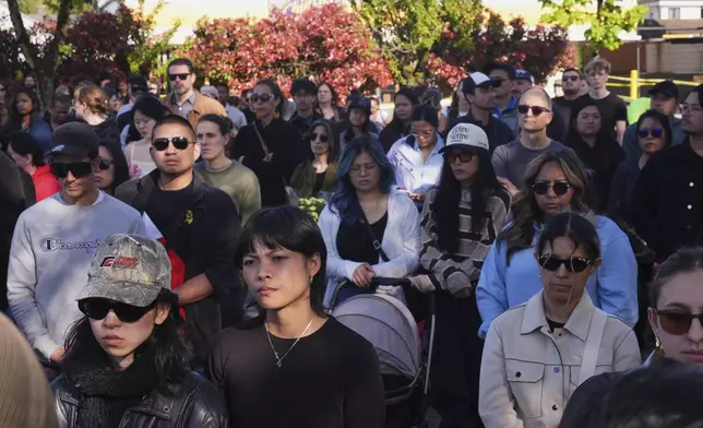 People visit a memorial after a vehicle drove into a crowd during a Filipino heritage festival in Vancouver, British Columbia, Sunday, April 27, 2025. (AP Photo/Lindsey Wasson)