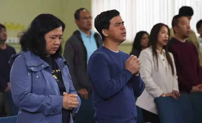 Adonis Quita, center, who witnessed the event, sings during a worship service at the Filipino Fellowship Baptist Church the day after a driver killed multiple people during a Filipino community festival Sunday, April 27, 2025, in Vancouver, British Columbia. (AP Photo/Lindsey Wasson)