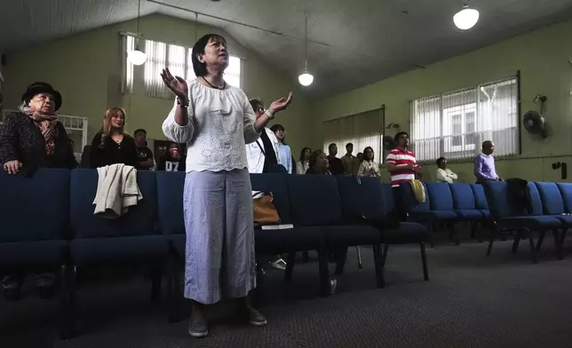 Rowena Cerdena sings during a worship service at the Filipino Fellowship Baptist Church in Vancouver, Canada, Sunday, April 27, 2025, the day after a driver killed multiple people at a Filipino community festival. (AP Photo/Lindsey Wasson)
