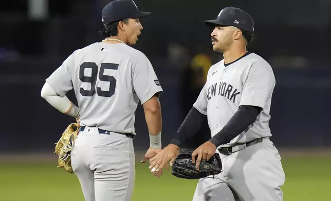 New York Yankees outfielder Trent Grisham, right, celebrates with third base Oswaldo Cabrera after the team defeated the Tampa Bay Rays during a baseball game Friday, April 18, 2025, in Tampa, Fla. (AP Photo/Chris O'Meara)