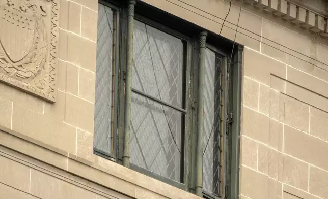 Wires are seen leading from a top floor corner window to the roof of the headquarters of the General Services Administration (GSA) Wednesday, April 2, 2025, in Washington. (AP Photo/Mark Schiefelbein)