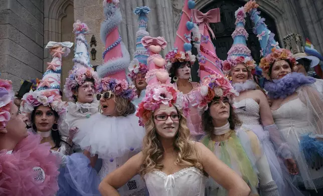 Revelers wearing decorated hats and costumes participate in the annual Easter Parade and Bonnet Festival in front of St. Patrick's Cathedral on Sunday, April 20, 2025, in New York. (AP Photo/Andres Kudacki)