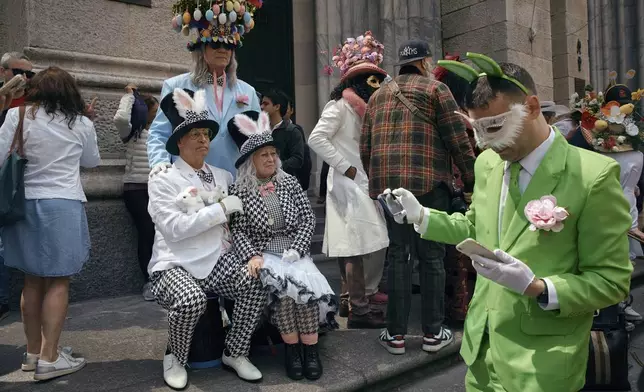 Revelers wearing decorated hats and costumes participate in the annual Easter Parade and Bonnet Festival in front of St. Patrick's Cathedral on Sunday, April 20, 2025, in New York. (AP Photo/Andres Kudacki)
