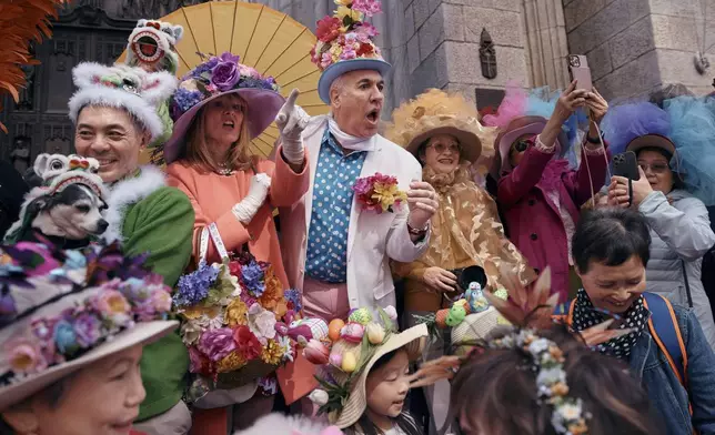 Revelers wearing decorated hats and costumes participate in the annual Easter Parade and Bonnet Festival in front of St. Patrick's Cathedral on Sunday, April 20, 2025, in New York. (AP Photo/Andres Kudacki)