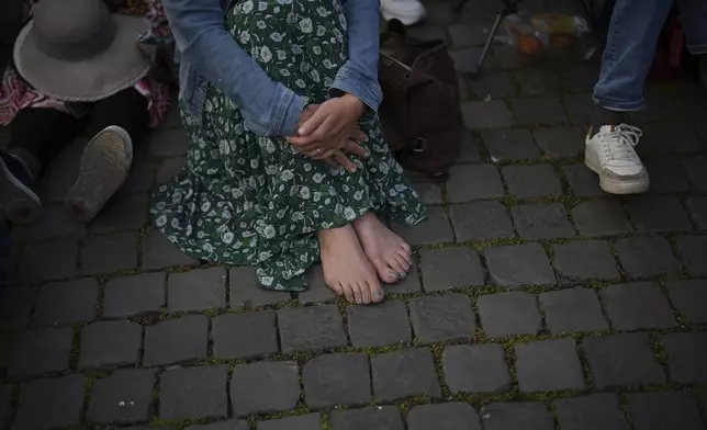 Nadine, from Germany, is waiting for the funeral of Pope Francis to begin, in St. Peter's Square at the Vatican, Saturday, April 26, 2025. (AP Photo/Emilio Morenatti)
