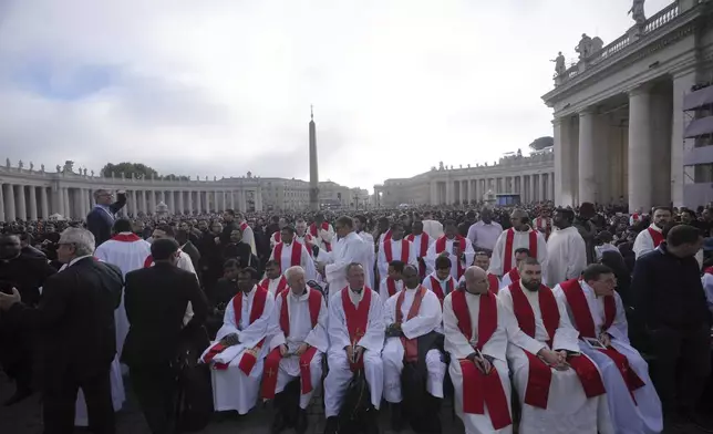 Priests take their seats ahead of the funeral of Pope Francis in St. Peter's Square at the Vatican, Saturday, April 26, 2025. (AP Photo/Alessandra Tarantino)