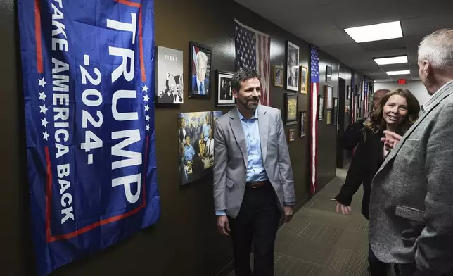 Ryan Kelley, left, arrives before his talk at the Jackson County Republican headquarters, Thursday, April 10, 2025, in Jackson, Mich. (AP Photo/Paul Sancya)