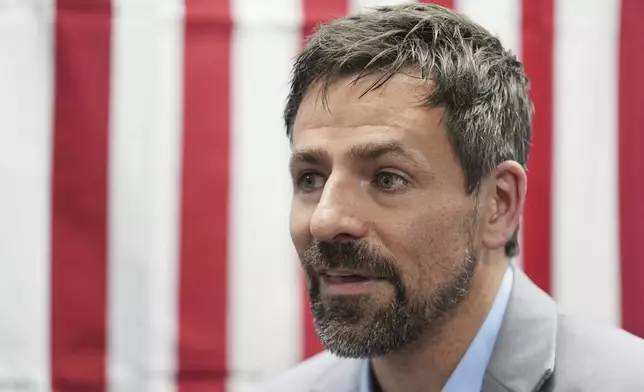 Ryan Kelley talks with attendees after speaking at the Jackson County Republican Party headquarters, Thursday, April 10, 2025, in Jackson, Mich. (AP Photo/Paul Sancya)