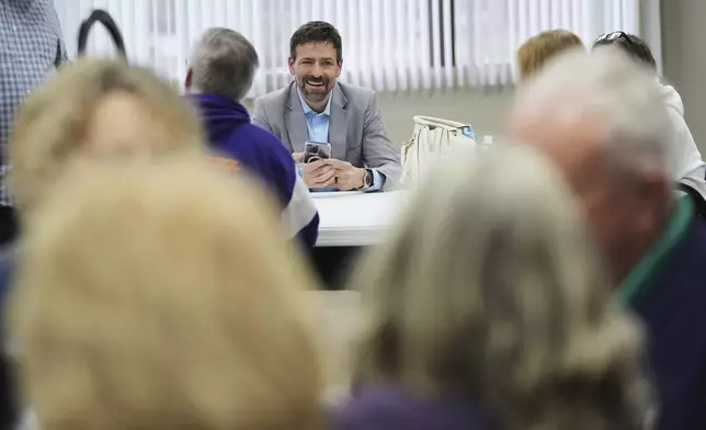 Ryan Kelley talks with attendees before speaking at the Jackson County Republican headquarters, Thursday, April 10, 2025, in Jackson, Mich. (AP Photo/Paul Sancya)