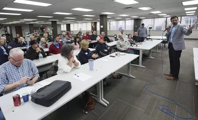 Ryan Kelley, right, speaks at the Jackson County Republican headquarters, Thursday, April 10, 2025, in Jackson, Mich. (AP Photo/Paul Sancya)