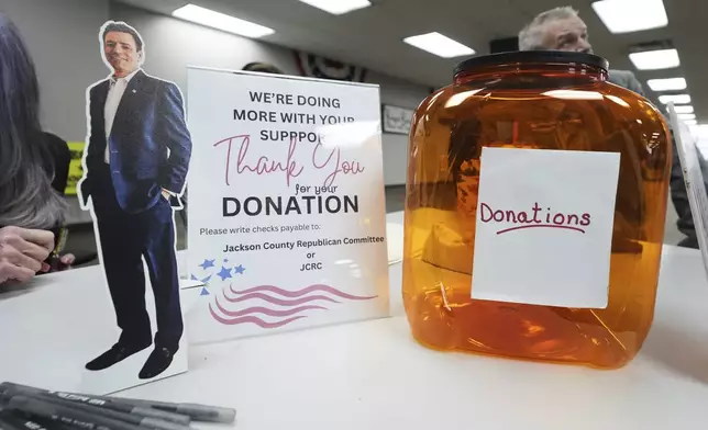 A small cutout of Ryan Kelley sits on the registration table before his talk at the Jackson County Republican headquarters, Thursday, April 10, 2025, in Jackson, Mich. (AP Photo/Paul Sancya)