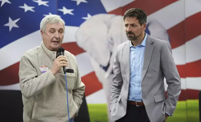 Ryan Kelley, right, listens to William "Hank" Choate speak at the Jackson County Republican headquarters, Thursday, April 10, 2025, in Jackson, Mich. (AP Photo/Paul Sancya)