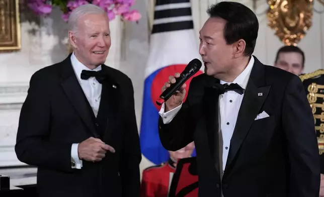 FILE - President Joe Biden listens as South Korea's President Yoon Suk Yeol sings the song American Pie by Don Mclean in the State Dining Room of the White House in Washington, on April 26, 2023, following the State Dinner. (AP Photo/Susan Walsh, File)