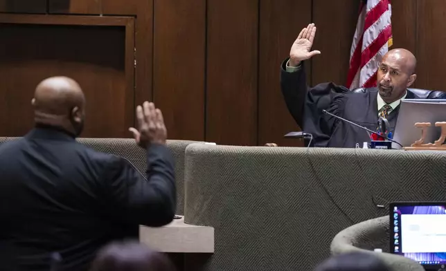 Desmond Mills Jr., a former Memphis Police Department officer who has taken a plea deal, left, is sworn in by Judge James Jones Jr., right, as a witness during the second day of the state trial for the death of Tyre Nichols at 201 Poplar in Memphis, Tenn., on Tuesday, April 29, 2025. (Chris Day/Commercial Appeal/USA Today Network via AP, Pool)