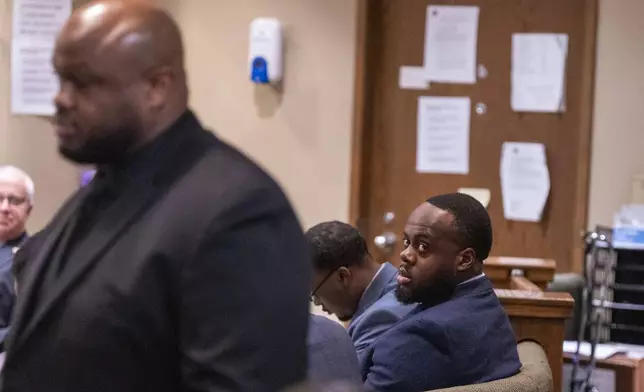 Former Memphis Police Department officer and defendant Tadarrius Bean, right, looks up as Desmond Mills Jr., left, a former MPD officer who has taken a plea deal, walks into the courtroom to take the stand as a witness during the second day of the state trial for the death of Tyre Nichols at 201 Poplar in Memphis, Tenn., on Tuesday, April 29, 2025. (Chris Day/Commercial Appeal/USA Today Network via AP, Pool)