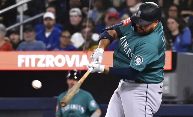 Seattle Mariners' Rowdy Tellez (23) hits a solo home run against the Toronto Blue Jays in the second inning of a baseball game in Toronto on Friday, April 18, 2025. (Jon Blacker/The Canadian Press via AP)
