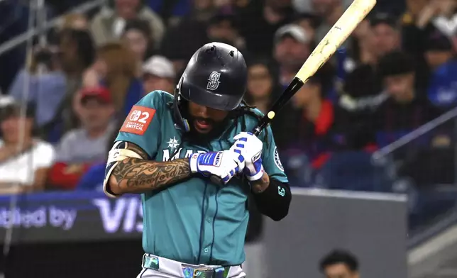 Seattle Mariners' J.P. Crawford (3) moves away from an inside pitch against the Toronto Blue Jays in the third inning of a baseball game in Toronto on Friday, April 18, 2025. (Jon Blacker/The Canadian Press via AP)